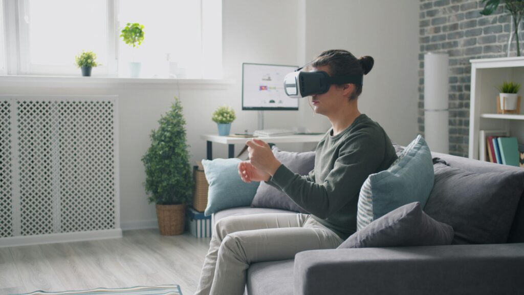 Adult using VR headset in a modern living room with plants and natural light.